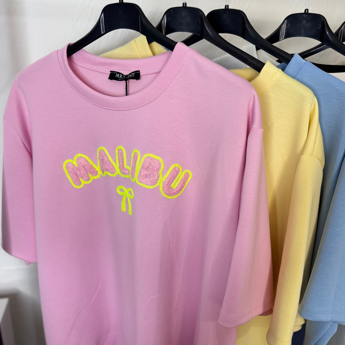 Lily - Oversized Malibu Flocking Stitch T-Shirt in Soft Pink with Bold Yellow Lettering and Bow Detail