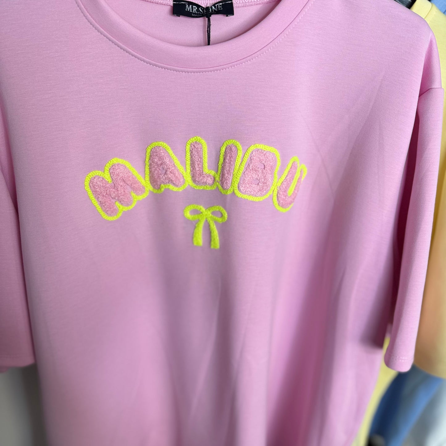 Lily - Oversized Malibu Flocking Stitch T-Shirt in Soft Pink with Bold Yellow Lettering and Bow Detail
