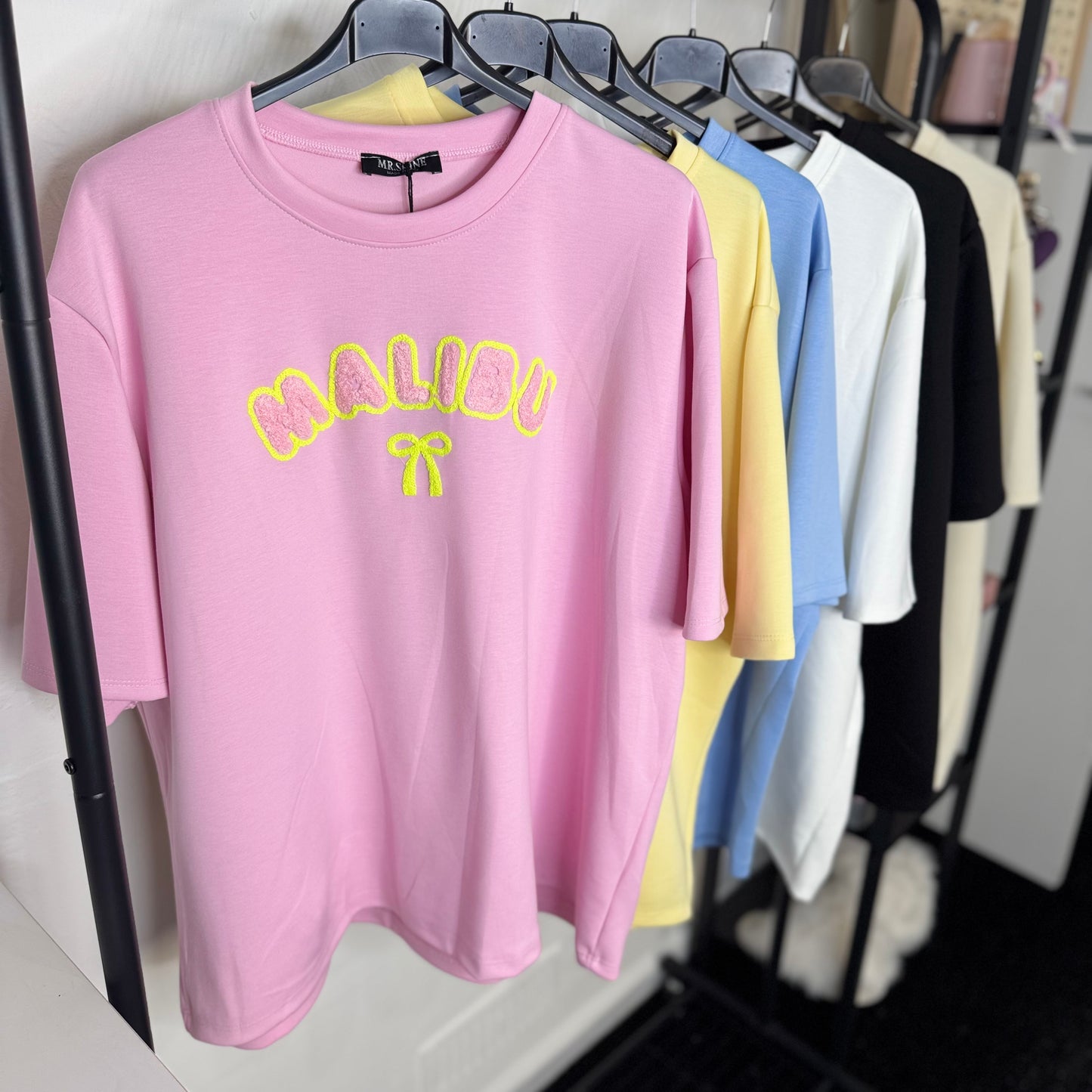 Lily - Oversized Malibu Flocking Stitch T-Shirt in Soft Pink with Bold Yellow Lettering and Bow Detail